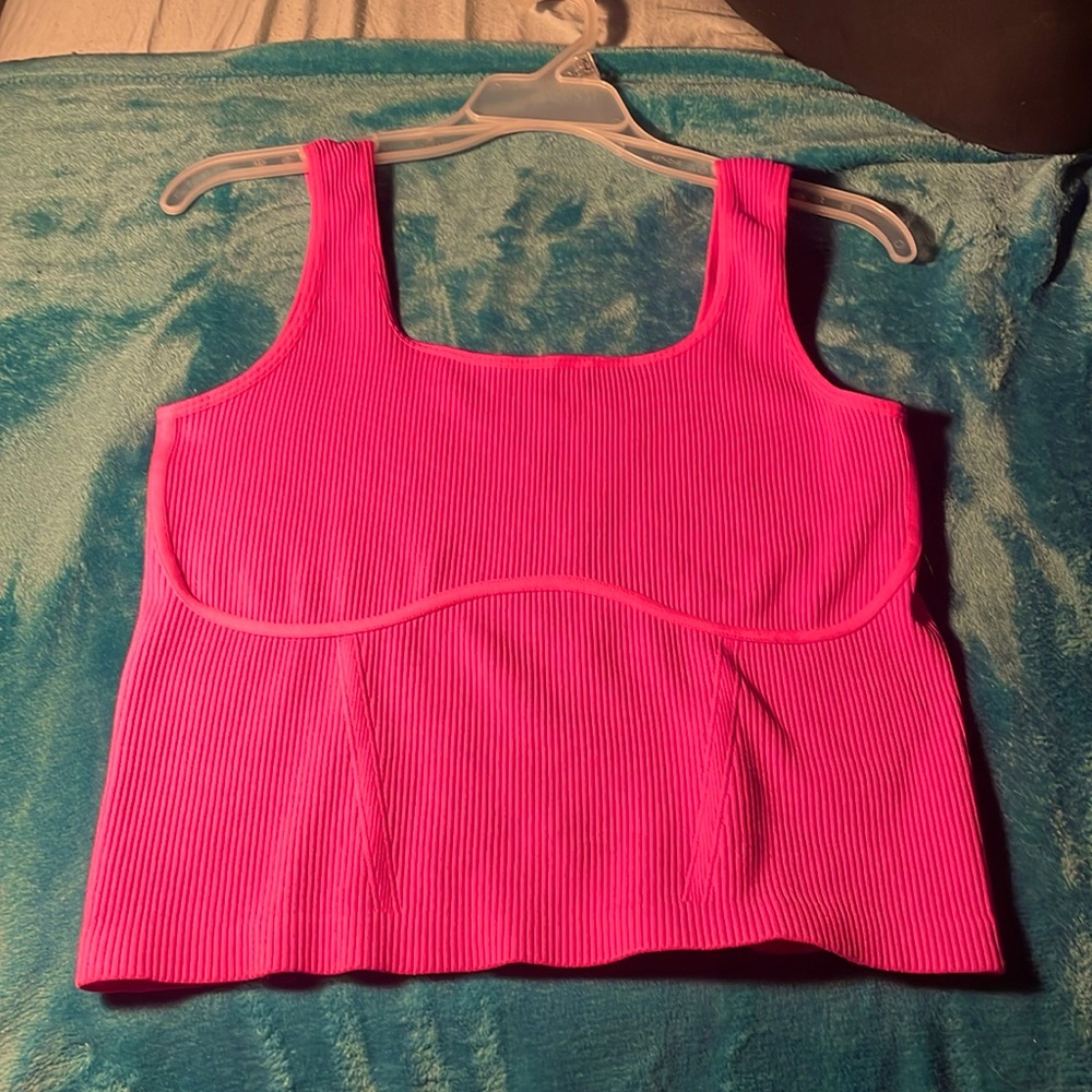 Hot pink tank top, slightly cropped depending on the person, fits size 6-12